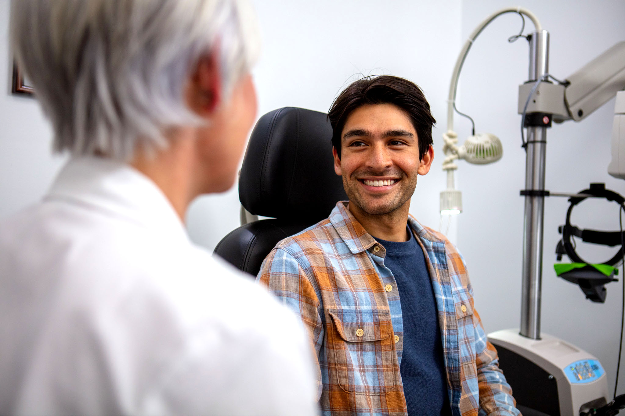 guy smiling sitting down looking at doctor